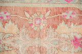 Distressed Oushak rug detail: worn pile, serrated palmette, pinwheel blossom, dusty raspberry, pale sandalwood.