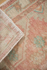 Oushak rug's distressed pile showing knot heads, exposed foundation, and side selvedge.