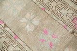 Distressed Oushak rug pile with magenta floral motifs, pale blue, and visible foundation.