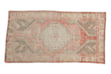 Distressed vintage Oushak runner with an abrashed pink field and a central ivory and silver medallion.