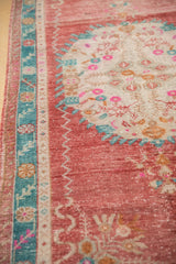 Textured vintage Oushak runner with raspberry red field, turquoise border, and bubblegum pink florals.