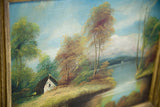 Quaint white cottage amidst green and autumn-colored trees in the oil painting.