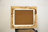 Vintage oil painting frame back with peeling paper and hanging wire.