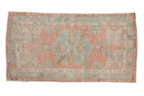 Distressed vintage Oushak rug, dusty rose field with mint green medallion and sprawling leaves.