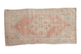 Distressed vintage Oushak runner with faded blush medallion, pale green floral, and soft aged patina.