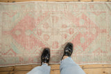 Distressed Oushak rug runner pattern with dusty blush, ivory, and pale green texture.