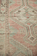 Hand-knotted texture showing the distressed pile in dusty rose and sea foam green.