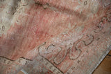 Hand-knotted Oushak rug pile with distressed texture and soft dusty rose tones.
