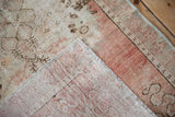 Distressed Oushak runner with textured pile, visible foundation, and pale sea foam selvage.