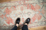 The scale and worn, hand-knotted texture of a distressed vintage Oushak runner.