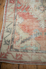 Detail of the primitive geometric blossom border with worn pile in cherry red and oxidized silver.