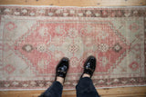 A scale view of the time-softened texture on a distressed vintage Oushak rug runner.