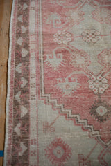 Corner detail of a vintage Oushak showing the stepped spandrel and blossom main border.