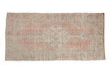 Vintage distressed Oushak runner with a stepped medallion design in dusty rose, silver, and ivory.