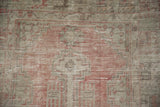 Vintage Oushak's hand-knotted texture, showing mostly even wear in dusty rose and silver tones.