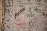 Distressed pink and silver Oushak runner side, showing floral border and coffee brown motifs.