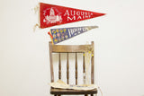 Vintage red Augusta, Maine and blue Halifax, N.S. felt flags hanging, showing age.
