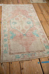 Angled view of the distressed Oushak runner, showing its time-worn texture and faded palette.