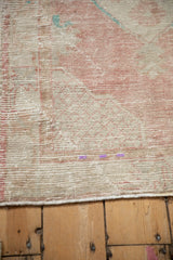 Detailed view of the vintage Oushak's characterful wear, showing its textured low pile.