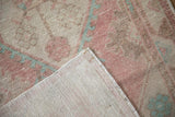 Hand-knotted foundation and secured side cord of a vintage distressed Oushak runner.