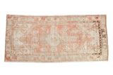 Vintage distressed Oushak rug runner with a faded medallion in soft dusty blush and antique ivory.