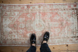 A look down at the time-softened texture of a vintage distressed Oushak rug.