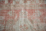Distressed Oushak pile showing wear across to the foundation and knot heads.