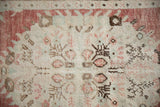 Low, hand-knotted pile of a distressed Oushak rug showing even wear to the knot heads.