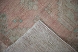 Hand-knotted foundation and distressed blush pile of the vintage Oushak runner.