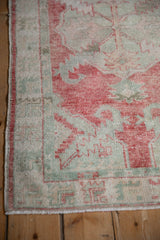 Detail of the intact side cord selvage and worn pile on a distressed vintage Oushak rug.