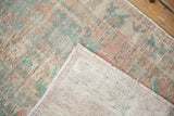Detail of the hand-knotted foundation and reverse side of a vintage distressed Oushak rug.