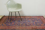 Intricate royal blue and rich red floral Kashan rug pattern with characterful white knots.