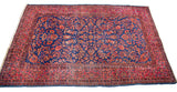 Antique Persian Kashan rug, royal blue field, rich red allover intricate floral pattern.