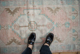 Vintage distressed Oushak runner, dusty rose medallion, pale turquoise florals, and feet.