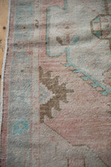 Distressed Oushak rug runner texture, dusty rose and turquoise pile, with worn foundation and selvage.
