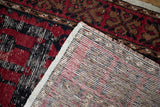 The hand-knotted foundation and distressed pile of a vintage Turkish Oushak rug corner.