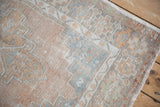 Time-softened pile of a vintage Oushak showing its geometric border in silver and sandalwood.