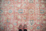 Distressed vintage Sparta carpet with dusty blush field and dusty denim blue palmettes.
