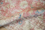 Close-up of distressed Sparta carpet showing faded dusty blush, ivory, and denim blue pile.