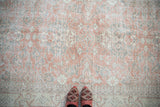 Distressed vintage Sparta rug with soft blush, silver, ivory floral field.