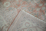 Distressed vintage Sparta pile in dusty blush, silver, ivory, showing bound edge and foundation.