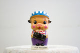 Vintage ceramic piggy bank of a pig in overalls holding a black car.