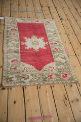 Distressed vintage Oushak rug, highlighting worn cherry red pile and stepped mehrab.