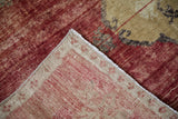 Vintage Kars rug's abrashed cherry red pile, woven beige foundation, and secured edge.