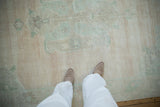 Soft wool pile of a vintage distressed Oushak showing even wear to the knots.