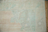 Evenly worn, hand-knotted pile of a vintage Oushak carpet in pale blush and mint green.