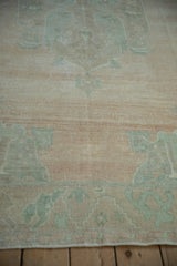 Soft, low wool pile on a distressed Oushak showing the abrashed field and even wear.