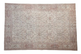Vintage distressed Oushak carpet with an all-over pattern of angular vines in dusty red and brown.