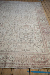Low-angle perspective of a distressed Turkish Oushak showing its time-softened geometric patterns and border.