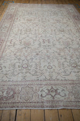 Lengthwise view of a distressed Oushak carpet showing its faded geometric and floral patterns.